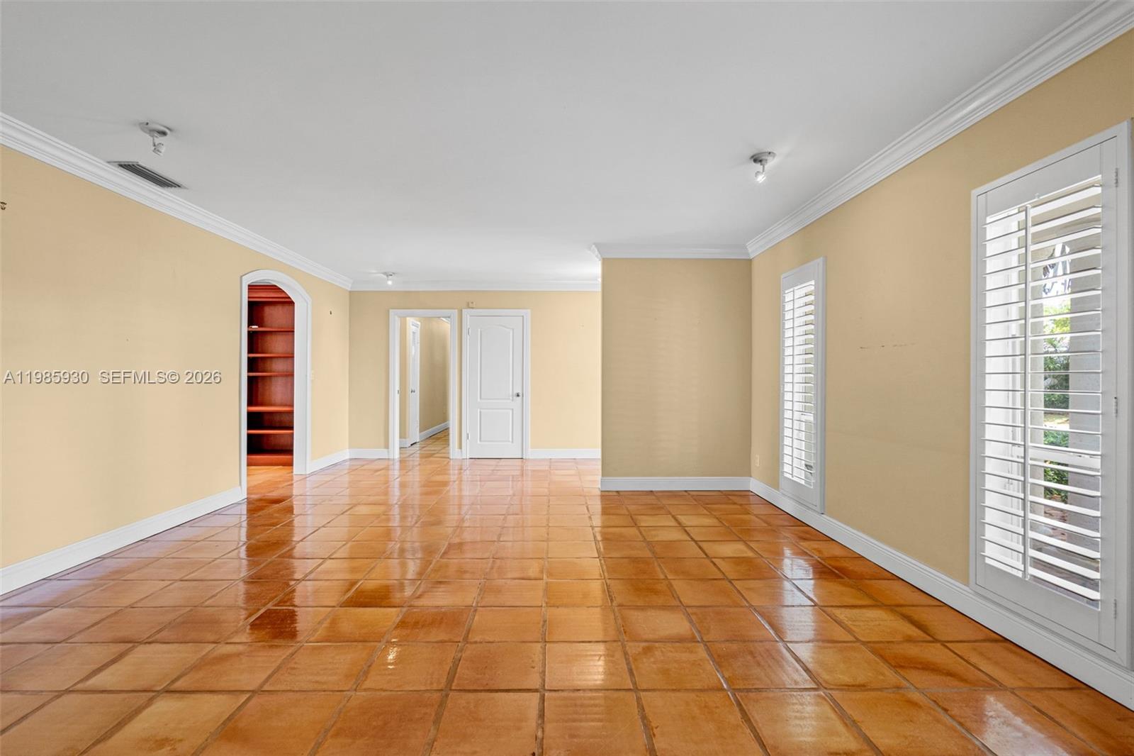 13276 Southwest 58th Court Pinecrest, FL 33156 - Photo 7 of 67 a view of an empty room with window and chandelier