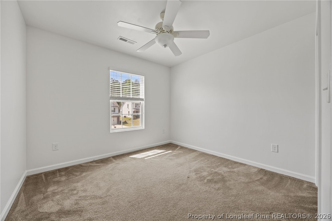 226 River Oak Street Spring Lake, NC 28390 - Photo 34 of 41 an empty room with windows and fan
