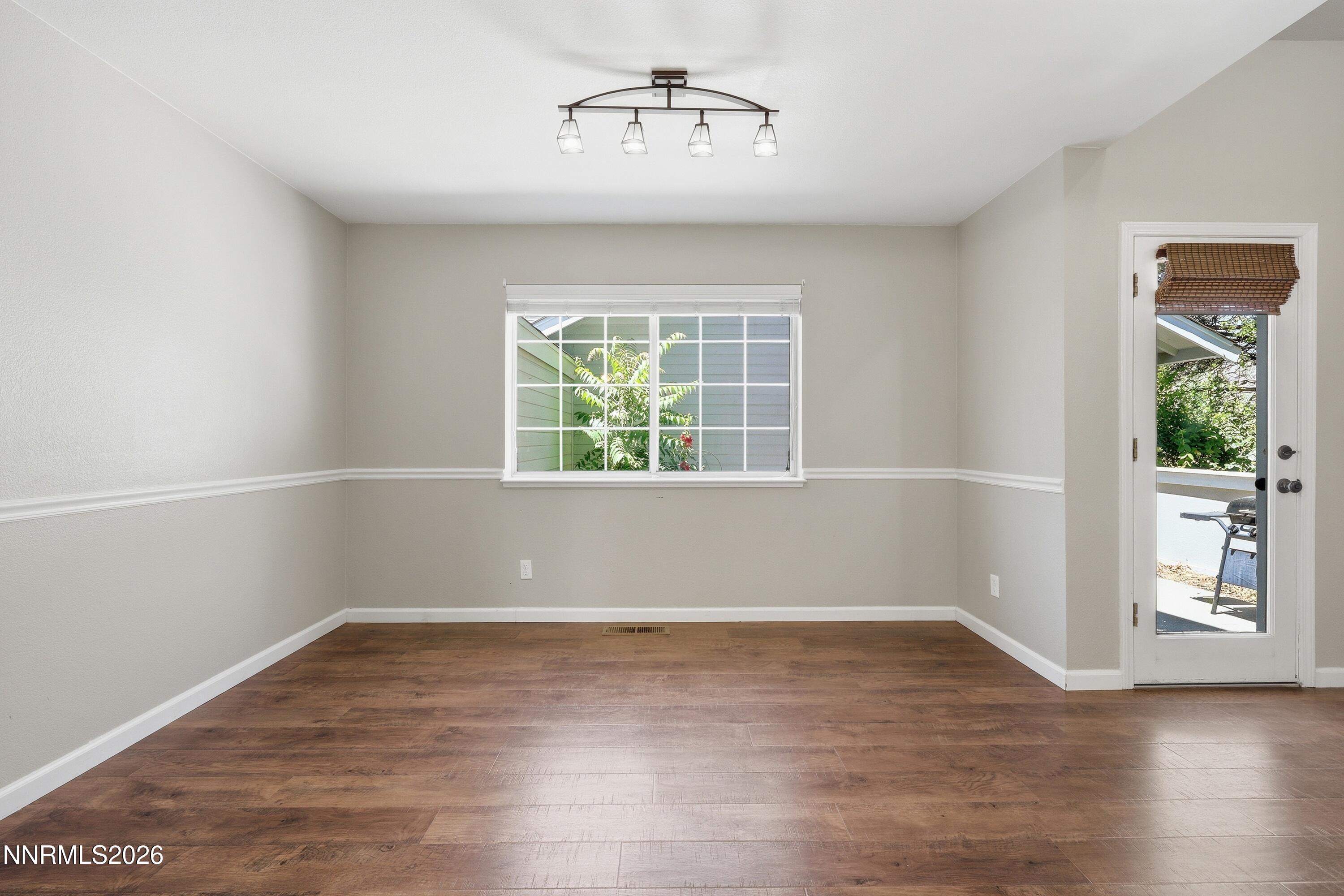 1899 Tuolumne Drive Reno, NV 89523 - Photo 9 of 44 an empty room with wooden floor and windows