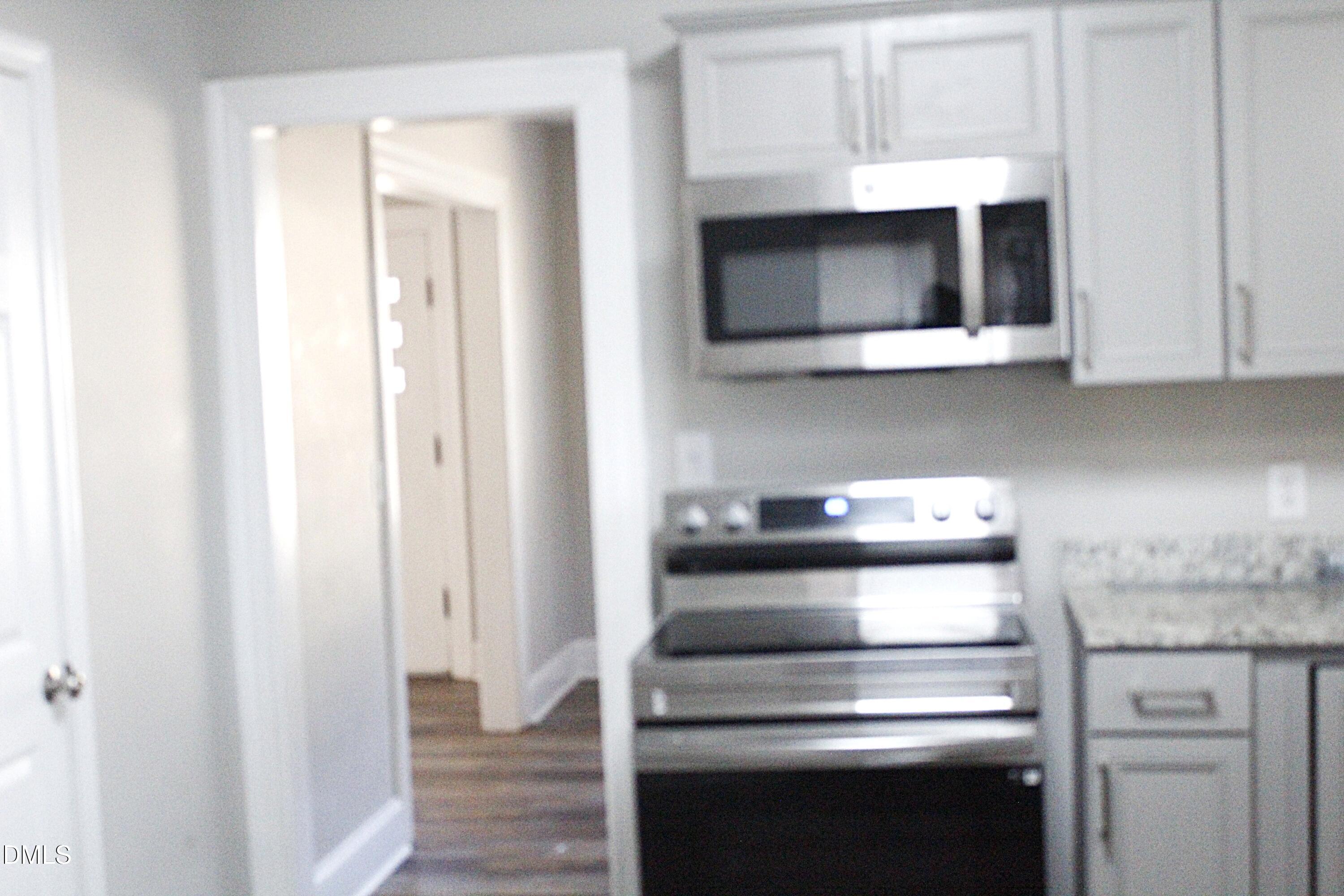 907 Leggett Road Rocky Mount, NC 27801 - Photo 11 of 23 a kitchen with stainless steel appliances granite countertop a stove and a microwave