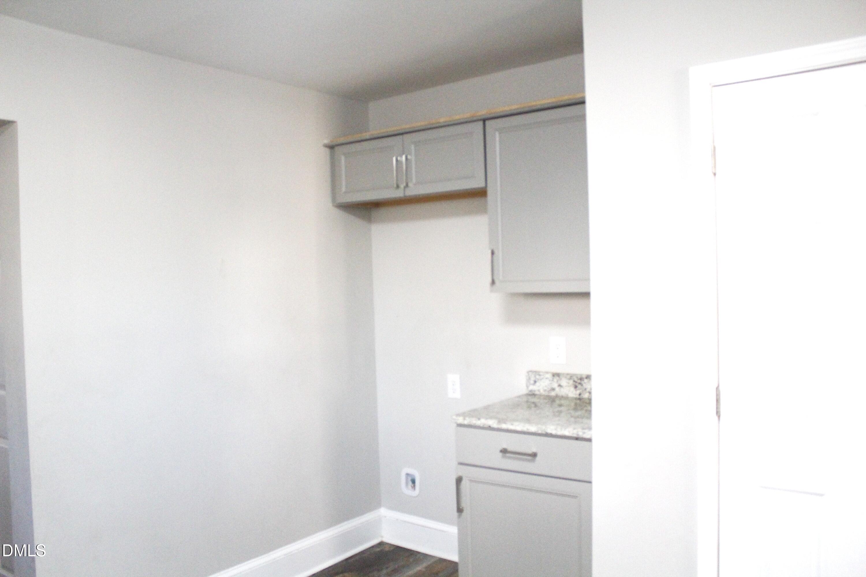 907 Leggett Road Rocky Mount, NC 27801 - Photo 12 of 23 a kitchen with a stove and a refrigerator
