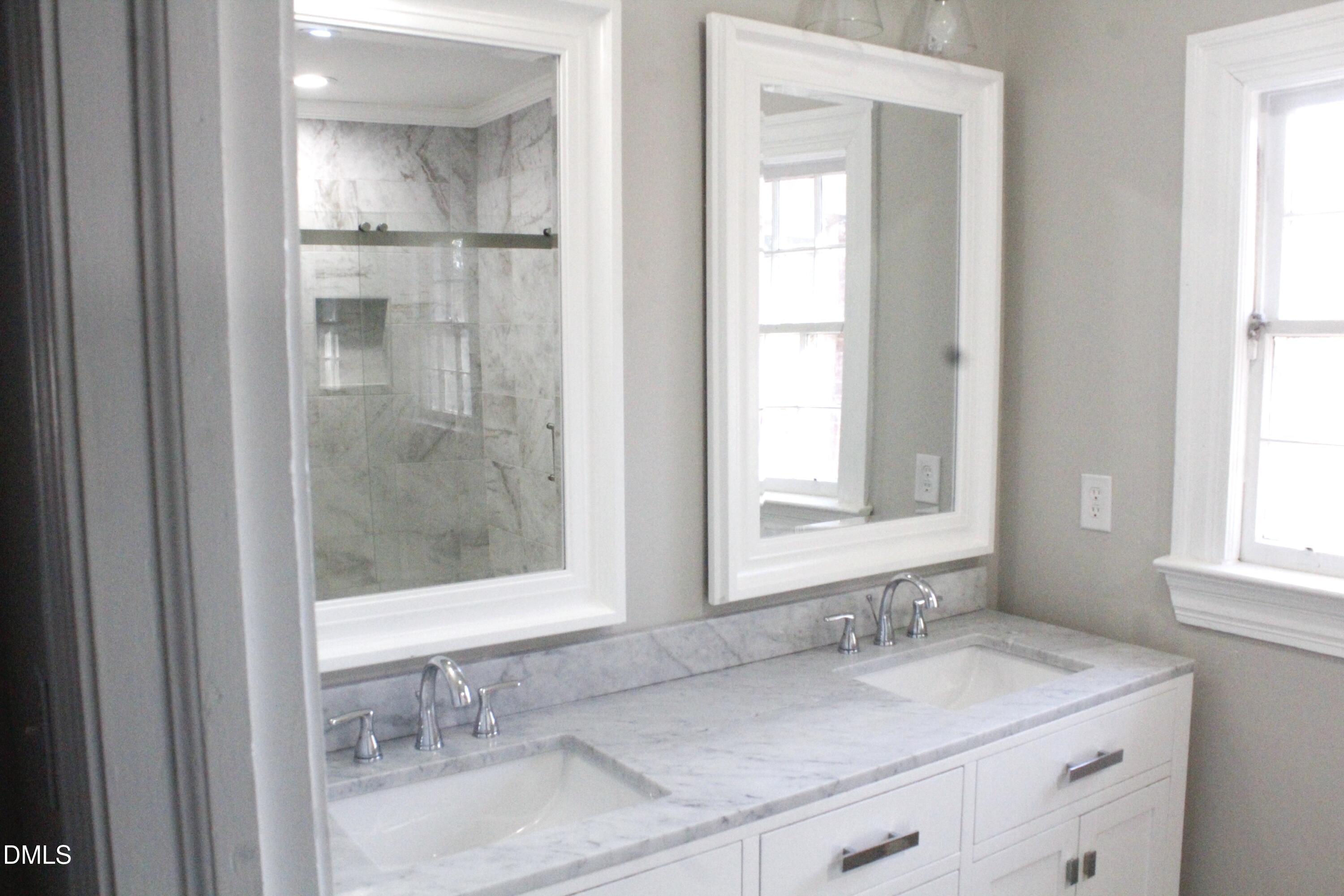 907 Leggett Road Rocky Mount, NC 27801 - Photo 13 of 23 a bathroom with a granite countertop sink mirror and next to a window