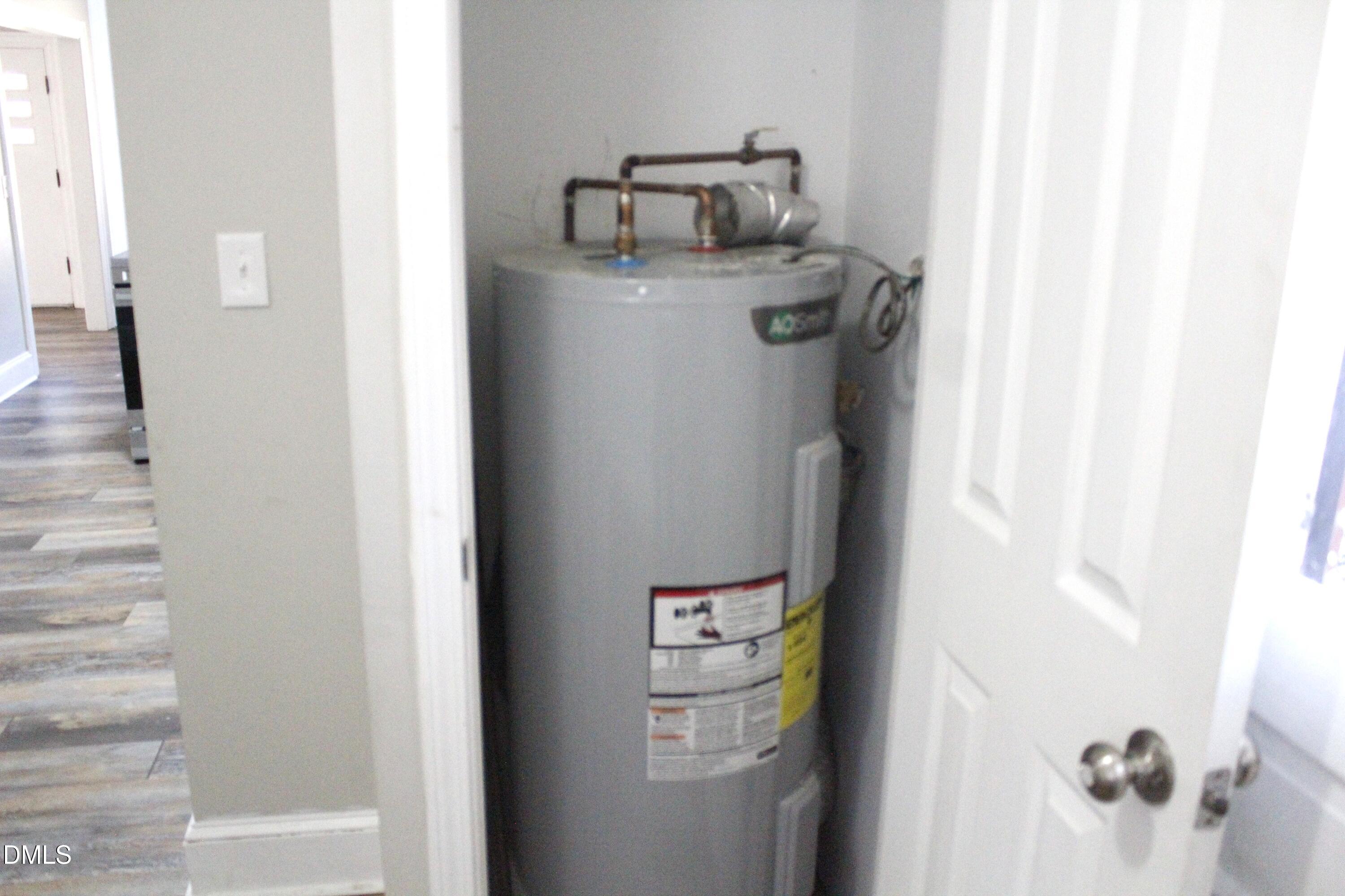 907 Leggett Road Rocky Mount, NC 27801 - Photo 21 of 23 a bathroom with a refrigerator and mirror