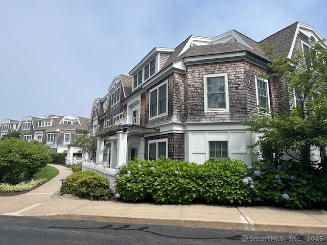 103 Main Street, Unit 2202 Stonington, CT 06378 - Photo 14 of 29 a front view of a house with a yard