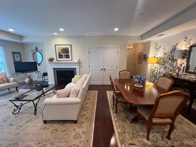 103 Main Street, Unit 2202 Stonington, CT 06378 - Photo 19 of 29 a living room with furniture a fireplace and a flat screen tv