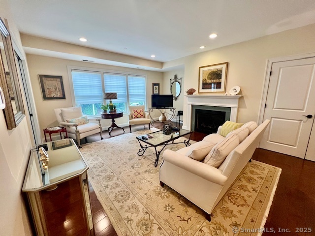 103 Main Street, Unit 2202 Stonington, CT 06378 - Photo 2 of 29 a living room with furniture a fireplace and a flat screen tv