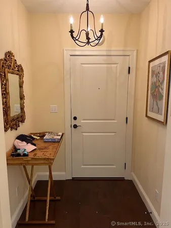 a view of a door and chair in wooden door