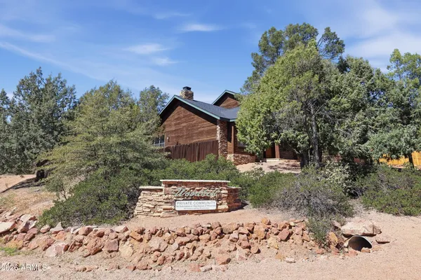 a view of a house with a yard and a tree