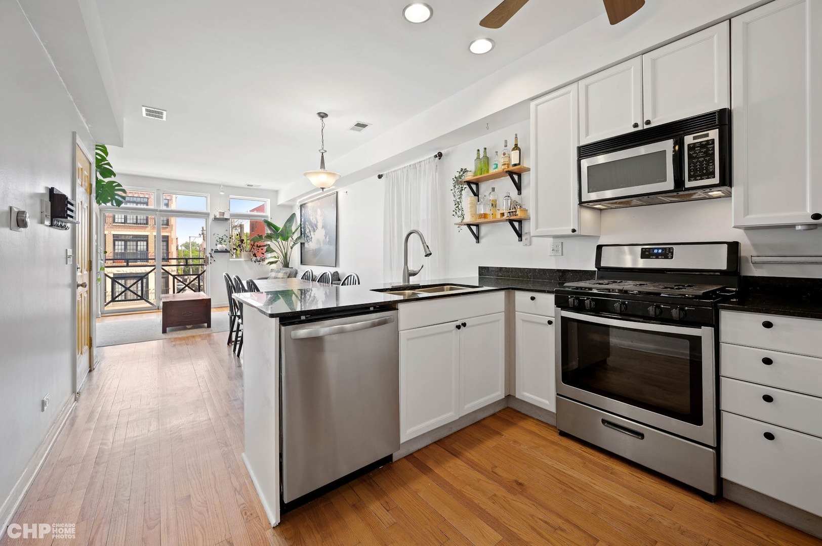2349 West Harrison Street, Unit 3 Chicago, IL 60612 - Photo 12 of 26 a kitchen with stainless steel appliances kitchen island granite countertop a stove and a sink