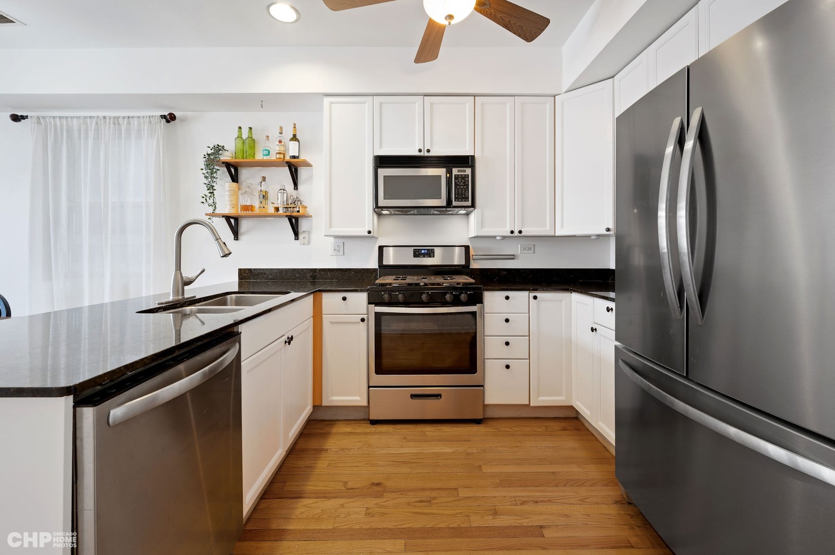 2349 West Harrison Street, Unit 3 Chicago, IL 60612 - Photo 13 of 26 a kitchen with stainless steel appliances a stove microwave and a refrigerator