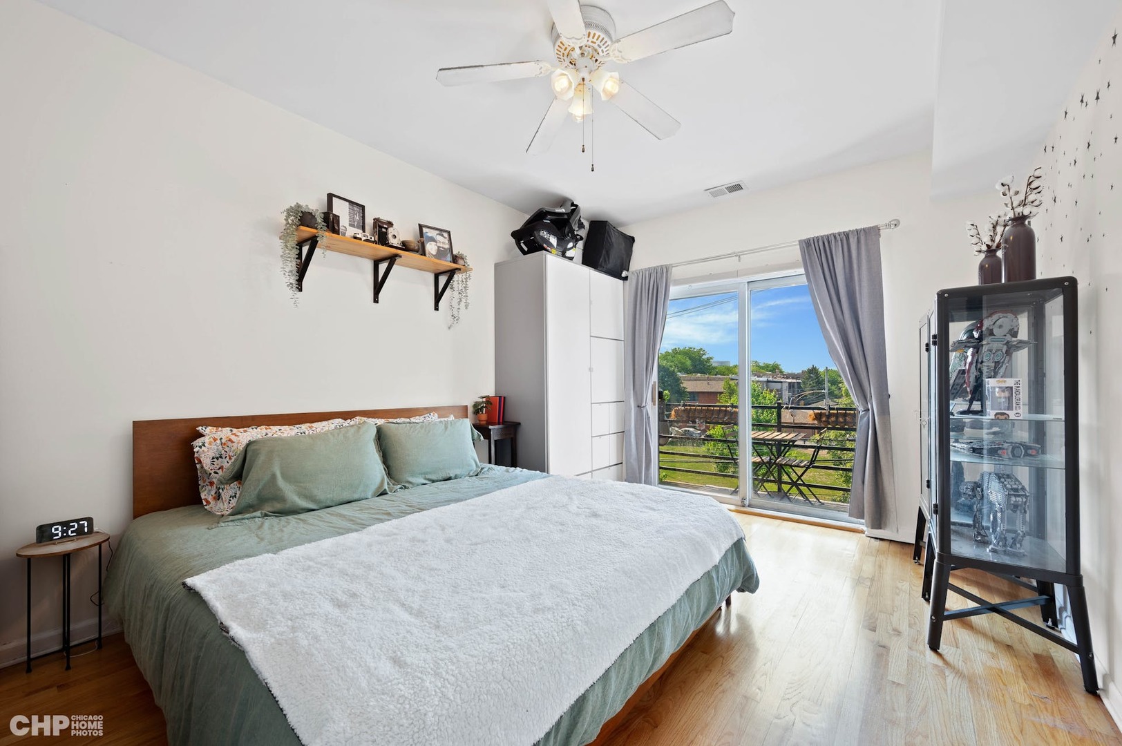 2349 West Harrison Street, Unit 3 Chicago, IL 60612 - Photo 15 of 26 a bedroom with a large bed and a chandelier