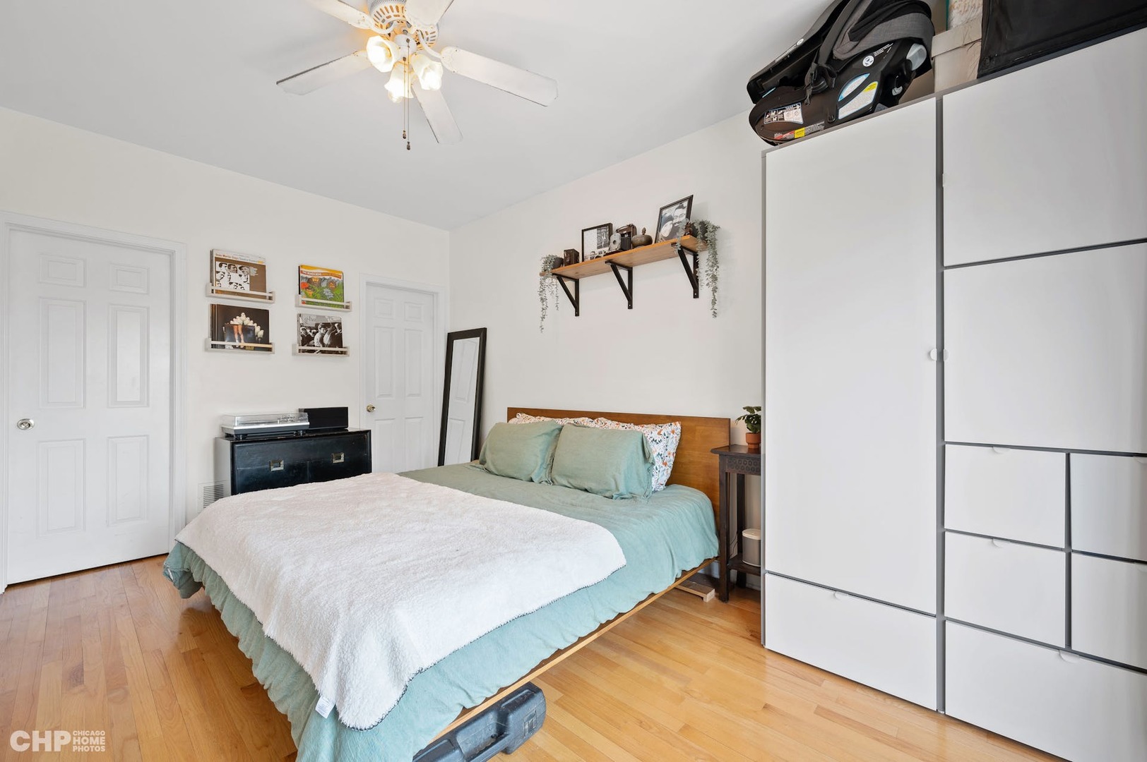2349 West Harrison Street, Unit 3 Chicago, IL 60612 - Photo 16 of 26 a bedroom with a bed and a chandelier