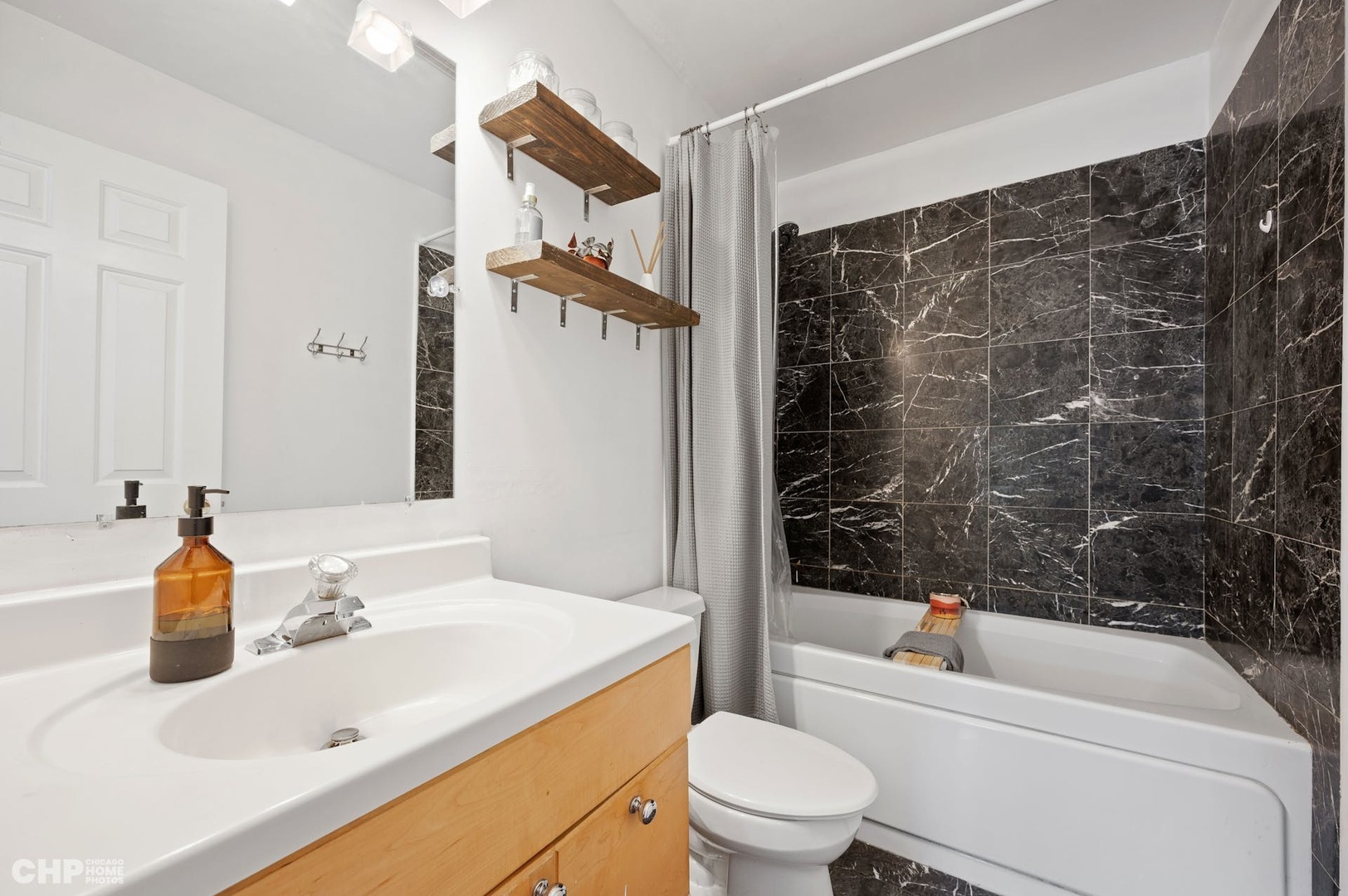 2349 West Harrison Street, Unit 3 Chicago, IL 60612 - Photo 18 of 26 a bathroom with a sink a toilet and shower