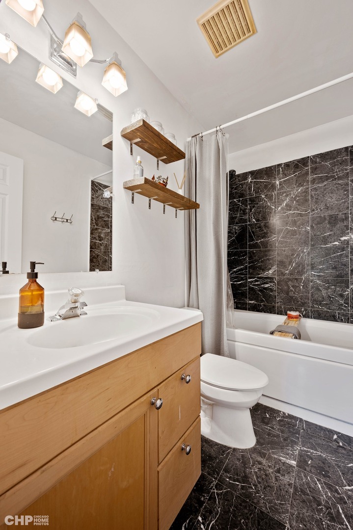 2349 West Harrison Street, Unit 3 Chicago, IL 60612 - Photo 19 of 26 a bathroom with a sink a toilet and shower