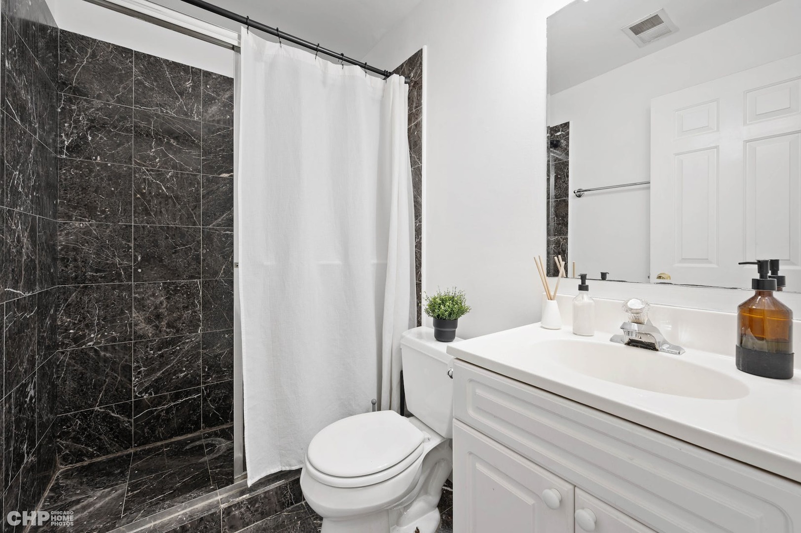 2349 West Harrison Street, Unit 3 Chicago, IL 60612 - Photo 21 of 26 a bathroom with a sink toilet and shower