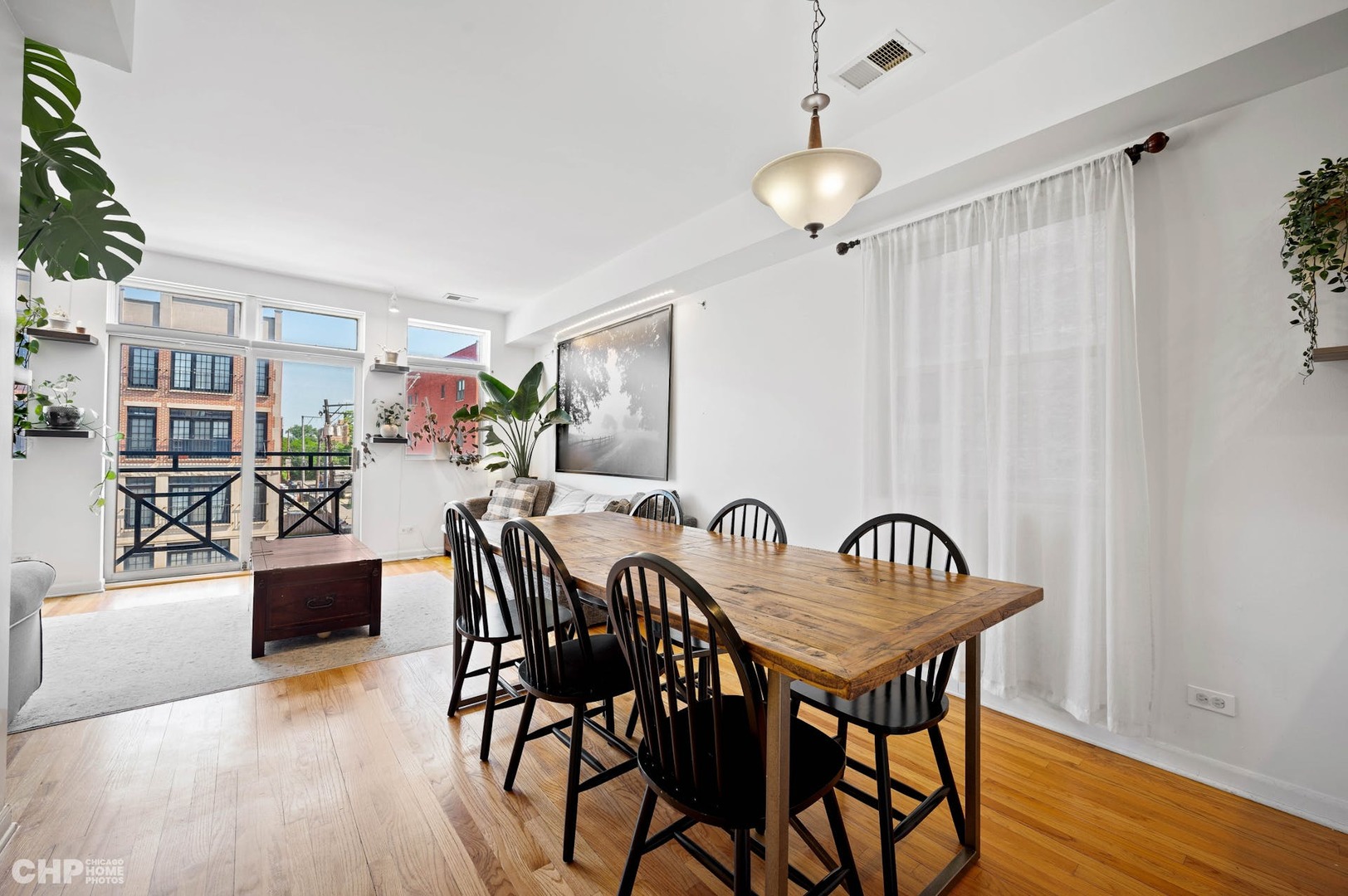2349 West Harrison Street, Unit 3 Chicago, IL 60612 - Photo 7 of 26 a view of a dining room with furniture and wooden floor