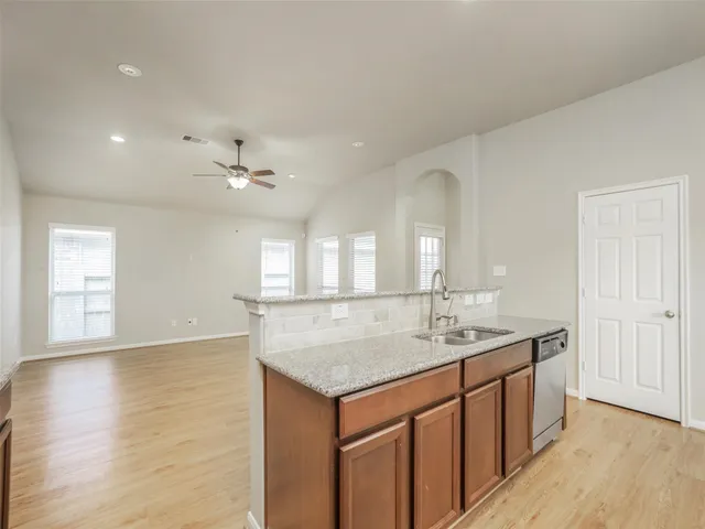 a bathroom with a granite countertop sink a large mirror and vanity