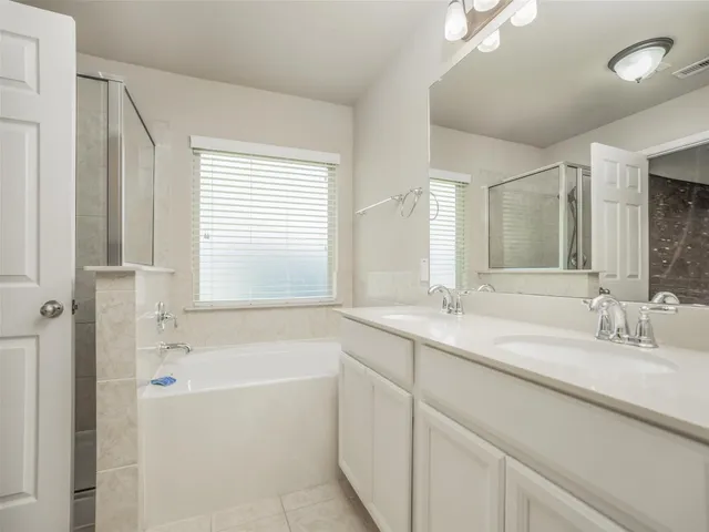 a bathroom with a granite countertop sink mirror bathtub and shower