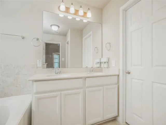 a bathroom with a sink double vanity and a mirror