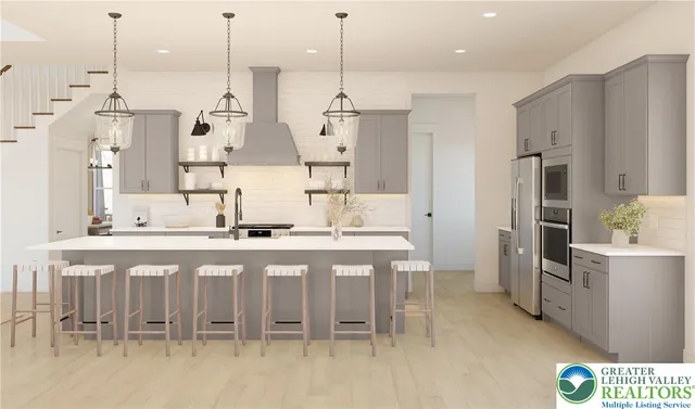 a kitchen with stainless steel appliances kitchen island granite countertop a table and chairs