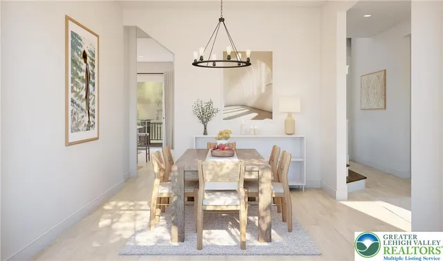 a dining room with furniture a chandelier and wooden floor