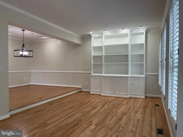 a view of staircase with lots of frames and a rug
