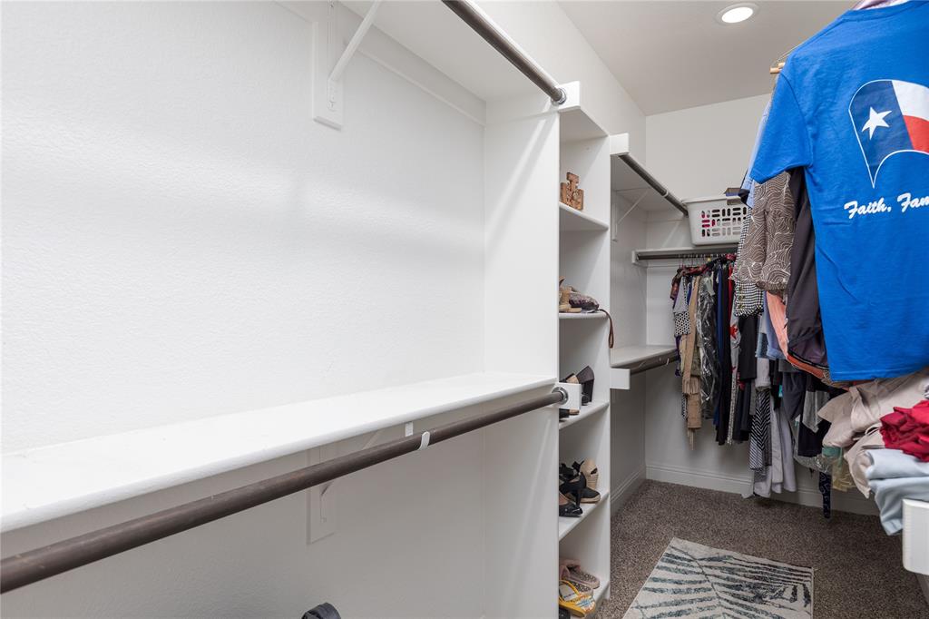 1008 Hummingbird Court Forney, TX 75126 - Photo 18 of 34 a view of walk in closet with clothes and shoes
