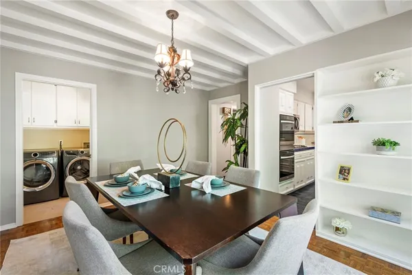 a view of a dining room with furniture and a chandelier