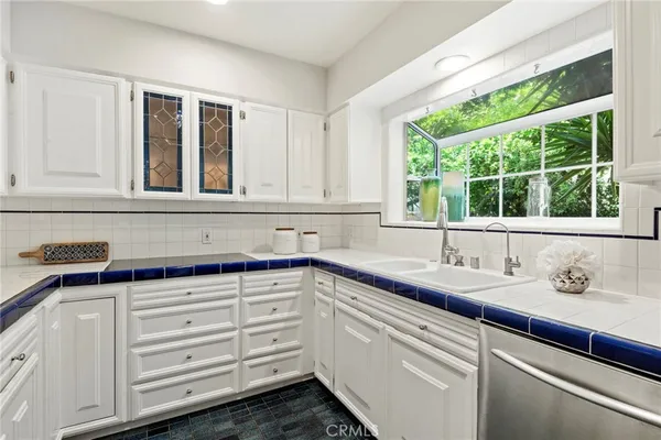 a kitchen with granite countertop a sink and a window