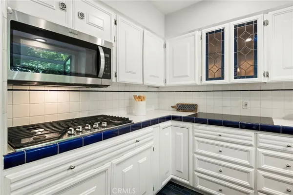 a kitchen with appliances a sink and cabinets