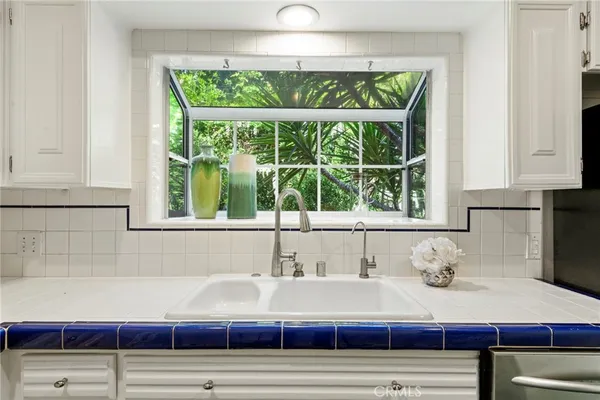 a bathroom with a sink and a large window
