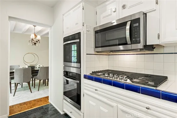 a kitchen with stainless steel appliances granite countertop a stove and a microwave