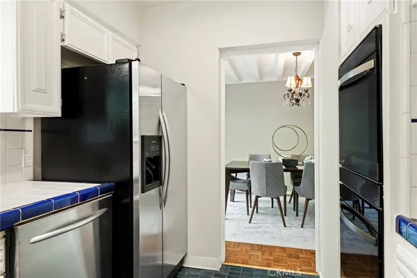 a kitchen with stainless steel appliances a refrigerator and a fireplace