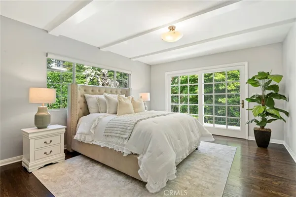a bedroom with a bed and a large window