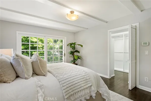 a large bed sitting in a bedroom next to a window