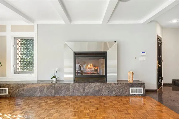 a living room with a fireplace and a window