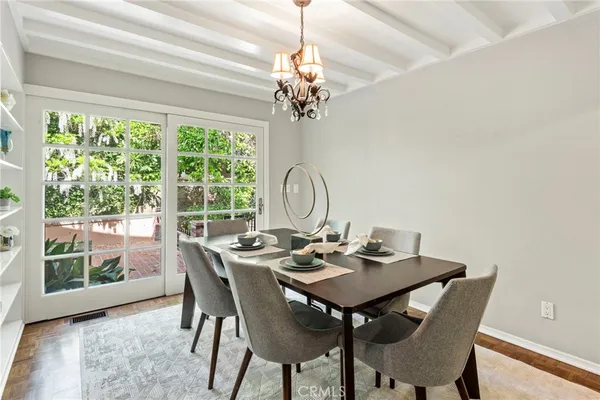 a view of a dining room with a table chairs and chandelier