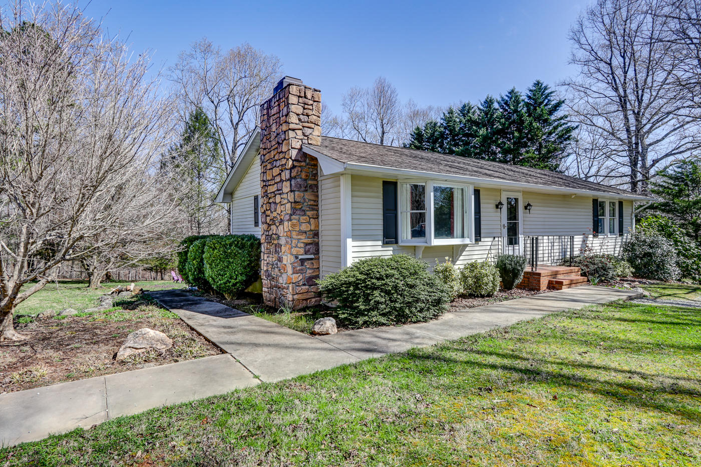 1306 Gills Road Bedford, VA 24523 - Photo 1 of 65 a front view of a house with garden and trees