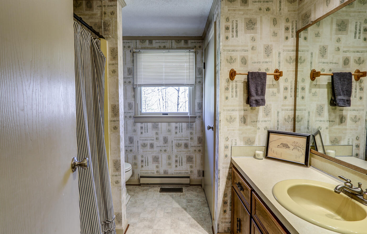1306 Gills Road Bedford, VA 24523 - Photo 28 of 65 a bathroom with a granite countertop sink a mirror and shower