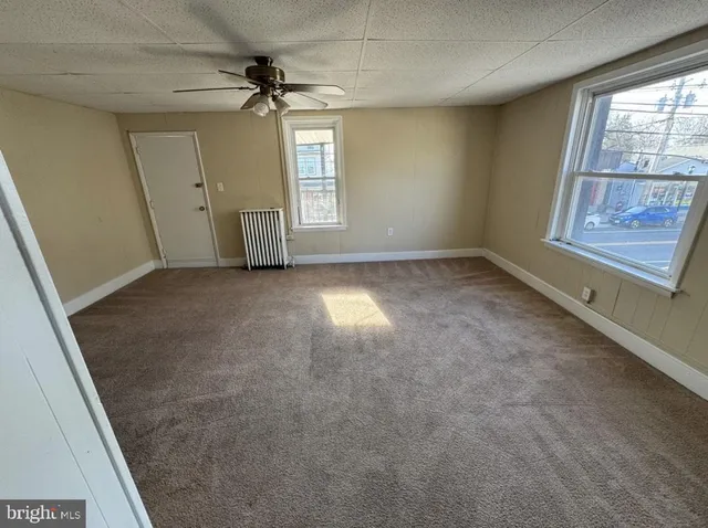 an empty room with windows and entrance