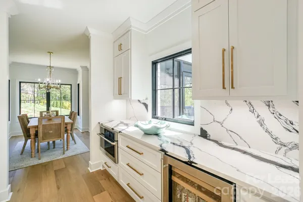 a kitchen with granite countertop sink cabinets and wooden floor
