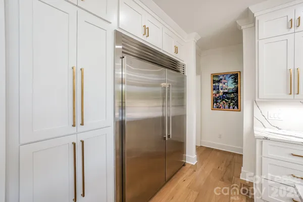 a kitchen with metallic refrigerator freezer and a dishwasher