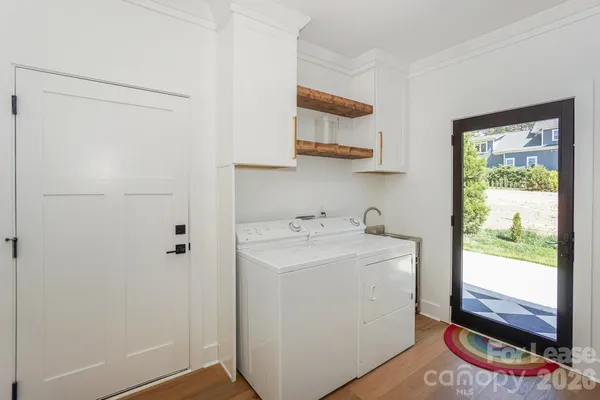 a utility room with cabinets washer and dryer