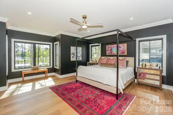 a bed room with a bed and a large window