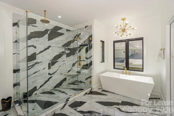 a bathroom with a bathtub and shower