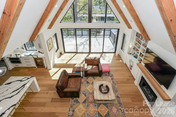 a living room with furniture and a floor to ceiling window