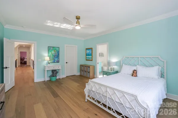 a bedroom with a bed and a chandelier