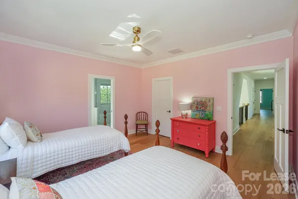 a bedroom with two beds and a chandelier
