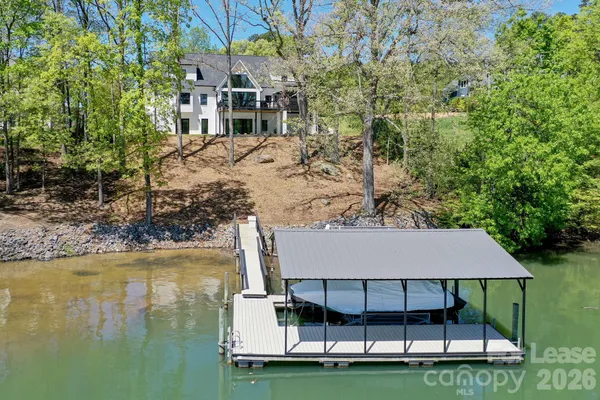 a view of a house with pool and yard