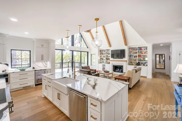 a large white kitchen with a large window